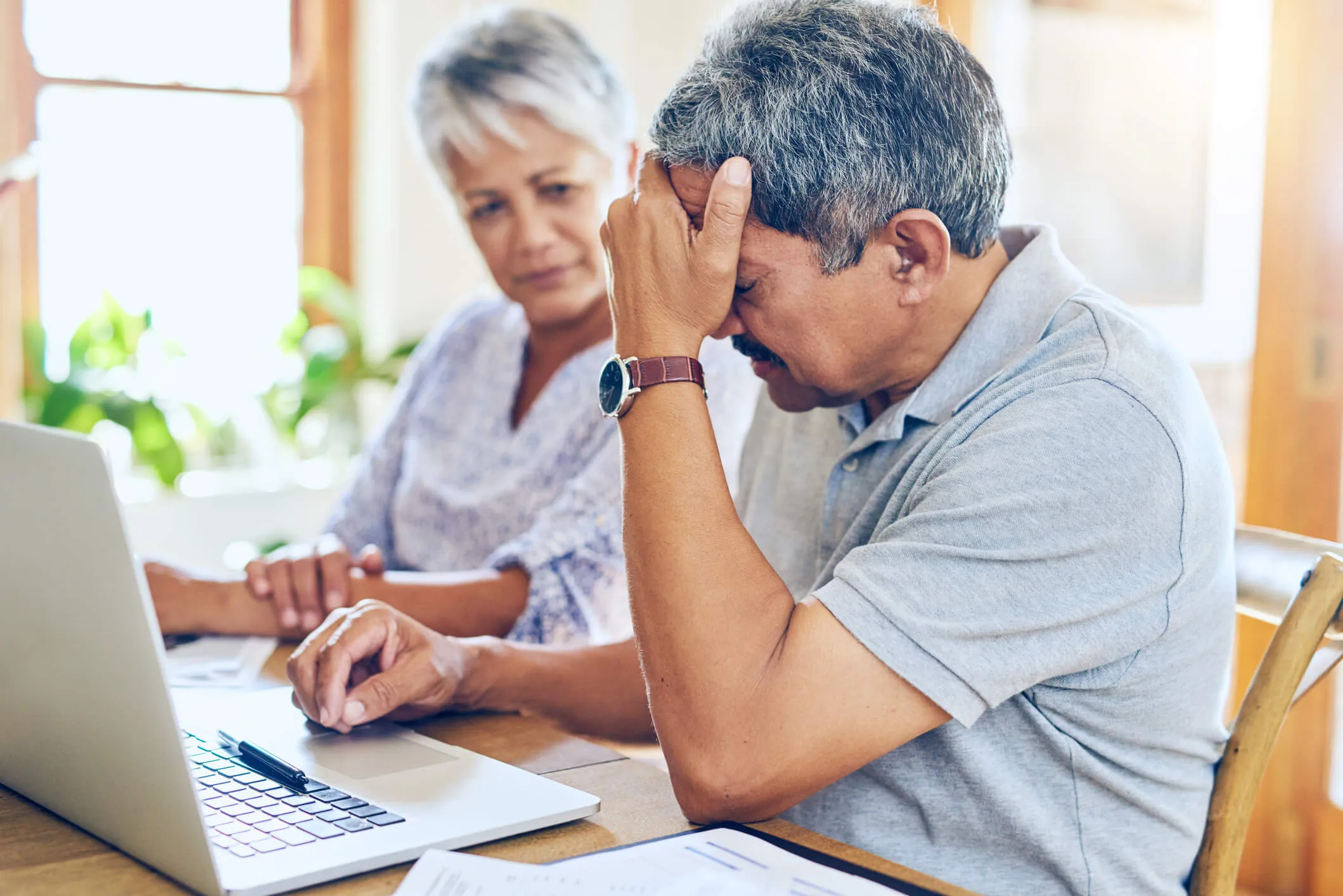 Senior couple reviewing long-term care cost documents together